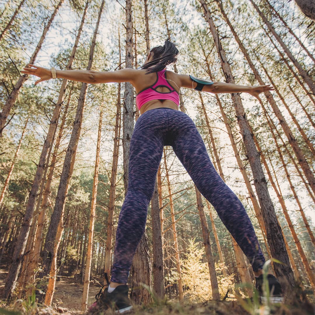 Woman out in the woods doing yoga